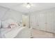 A cozy bedroom with light walls, carpet floors, closet, and natural light at 11333 Snapfinger Dr, Charlotte, NC 28277