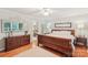 Bedroom featuring hardwood floors, a large bed, and access to the bathroom at 11333 Snapfinger Dr, Charlotte, NC 28277