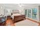 Bright bedroom with a large window, ceiling fan, and hardwood floors at 11333 Snapfinger Dr, Charlotte, NC 28277