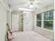 A sunny bedroom with neutral walls, complete with closet and guitar at 11333 Snapfinger Dr, Charlotte, NC 28277