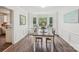Bright dining room with a bay window featuring a cushioned window seat and a rustic table at 11333 Snapfinger Dr, Charlotte, NC 28277