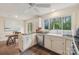 Well-lit kitchen with stainless steel dishwasher, stone tile floors, and white cabinets at 11333 Snapfinger Dr, Charlotte, NC 28277