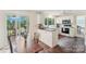 Bright kitchen with stone tile floors, white cabinets, and a sliding door to the deck at 11333 Snapfinger Dr, Charlotte, NC 28277