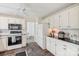 Spacious kitchen with white cabinets, stone floors, and stainless steel appliances at 11333 Snapfinger Dr, Charlotte, NC 28277