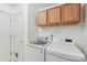 Functional laundry room with overhead cabinets and modern washer and dryer units at 11333 Snapfinger Dr, Charlotte, NC 28277