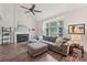 Cozy living room featuring a fireplace, vaulted ceilings, and a large window with natural light at 11333 Snapfinger Dr, Charlotte, NC 28277
