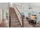Grand staircase with carpet steps, wood railing, and views of the living area at 11333 Snapfinger Dr, Charlotte, NC 28277