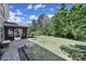 Spacious backyard with lush lawn, landscaping, a brick patio and a screened porch at 128 Front Porch Dr, Rock Hill, SC 29732