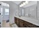 Bathroom vanity with brown cabinets, a white countertop, and a large mirror at 128 Front Porch Dr, Rock Hill, SC 29732