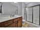 Modern bathroom boasts a wood vanity, tiled flooring, and a glass-enclosed shower at 128 Front Porch Dr, Rock Hill, SC 29732