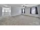 Large bedroom with neutral carpet, ceiling fan, and two windows offering plenty of natural light at 128 Front Porch Dr, Rock Hill, SC 29732