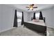 This bedroom features a ceiling fan, two windows with good light, and neutral carpet at 128 Front Porch Dr, Rock Hill, SC 29732