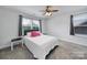 Cozy bedroom featuring a ceiling fan, two windows, and neutral carpet, perfect for relaxation at 128 Front Porch Dr, Rock Hill, SC 29732