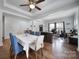 Bright open-concept dining area features stylish blue chairs, hardwood floors and easy access to a home office at 128 Front Porch Dr, Rock Hill, SC 29732