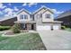 Charming home features a brick and siding facade, a covered front porch, and a spacious three-car garage at 128 Front Porch Dr, Rock Hill, SC 29732