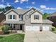 Charming two-story home with a three-car garage, stone accents, and welcoming curb appeal at 128 Front Porch Dr, Rock Hill, SC 29732