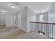 Hallway with carpet and views of the foyer, a pendant light, and wooden handrails at 128 Front Porch Dr, Rock Hill, SC 29732