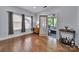 Cozy living room featuring hardwood floors, natural light, and a doorway to the outdoor patio at 128 Front Porch Dr, Rock Hill, SC 29732