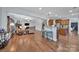 Open-concept living space with hardwood floors connects the cozy living room to the kitchen with counter seating at 128 Front Porch Dr, Rock Hill, SC 29732