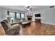Cozy living room with a stone fireplace and hardwood flooring, perfect for relaxing at 128 Front Porch Dr, Rock Hill, SC 29732