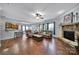 Open-concept living room features a stone fireplace, ceiling fan, and hardwood flooring at 128 Front Porch Dr, Rock Hill, SC 29732