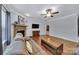 Spacious living room with a stone fireplace, hardwood flooring, and a ceiling fan at 128 Front Porch Dr, Rock Hill, SC 29732