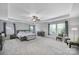 Bright main bedroom with tray ceilings, neutral carpet, and seating area with lots of natural light at 128 Front Porch Dr, Rock Hill, SC 29732