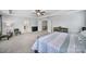 This main bedroom has neutral carpet, a ceiling fan, seating area, and a view of the bath and closet at 128 Front Porch Dr, Rock Hill, SC 29732