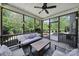 The cozy screened porch with a ceiling fan, comfortable seating, and views of the backyard at 128 Front Porch Dr, Rock Hill, SC 29732