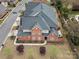 Aerial view of a well-kept brick home showcasing the roof, lawn, and landscaping at 130 Villa Lake Dr, Fort Mill, SC 29708