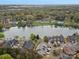 Aerial view showcasing a community pool with surrounding lake and lush greenery at 130 Villa Lake Dr, Fort Mill, SC 29708