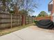 Fenced backyard with concrete patio and brick grill, perfect for outdoor gatherings at 130 Villa Lake Dr, Fort Mill, SC 29708