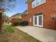Charming brick home backyard with concrete patio, brick grill, and manicured lawn space at 130 Villa Lake Dr, Fort Mill, SC 29708
