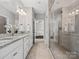 Elegant bathroom featuring a double sink vanity, granite countertops, and a walk-in glass shower at 130 Villa Lake Dr, Fort Mill, SC 29708