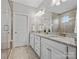 Bright bathroom features a double sink vanity with granite countertops and a glass enclosed shower at 130 Villa Lake Dr, Fort Mill, SC 29708