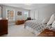 Carpeted bedroom with wooden chest and chair near a window at 130 Villa Lake Dr, Fort Mill, SC 29708