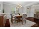 Elegant dining room featuring a wooden table, plush chairs, and sophisticated chandelier lighting at 130 Villa Lake Dr, Fort Mill, SC 29708