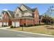 Beautiful brick home with manicured lawn, complemented by mature trees and attractive landscaping at 130 Villa Lake Dr, Fort Mill, SC 29708