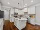 Well-lit kitchen boasts white cabinetry, granite countertops, stainless steel appliances, and central island at 130 Villa Lake Dr, Fort Mill, SC 29708
