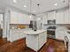 Modern kitchen features white cabinetry, granite countertops, stainless steel appliances, and a center island at 130 Villa Lake Dr, Fort Mill, SC 29708