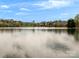 Scenic lake view with neighborhood homes visible on the opposite shore at 130 Villa Lake Dr, Fort Mill, SC 29708