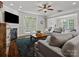 Cozy living room featuring plush seating, a fireplace, and natural light from the patio doors at 130 Villa Lake Dr, Fort Mill, SC 29708