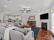 Spacious living room seamlessly connected to the kitchen, featuring modern decor and a fireplace at 130 Villa Lake Dr, Fort Mill, SC 29708