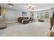 Spacious living room with plush carpeting, a ceiling fan, and abundant natural light at 130 Villa Lake Dr, Fort Mill, SC 29708