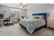 Cozy bedroom with a ceiling fan, large window, and comfortable seating area at 130 Villa Lake Dr, Fort Mill, SC 29708