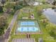 Aerial view showcasing the community's tennis and basketball courts, playground, and lakeside location at 130 Villa Lake Dr, Fort Mill, SC 29708