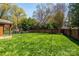 Well-manicured backyard with a lush green lawn, brick fencing, and a play set at 139 S Laurel Ave, Charlotte, NC 28207