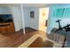 Basement with an exercise bike, TV, wood flooring, and an adjacent full bathroom at 139 S Laurel Ave, Charlotte, NC 28207