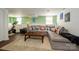 Basement living area featuring large sectional, Peloton exercise bike, and bright decor at 139 S Laurel Ave, Charlotte, NC 28207