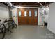 Spacious unfinished basement with large wooden doors and room for multiple bikes at 139 S Laurel Ave, Charlotte, NC 28207